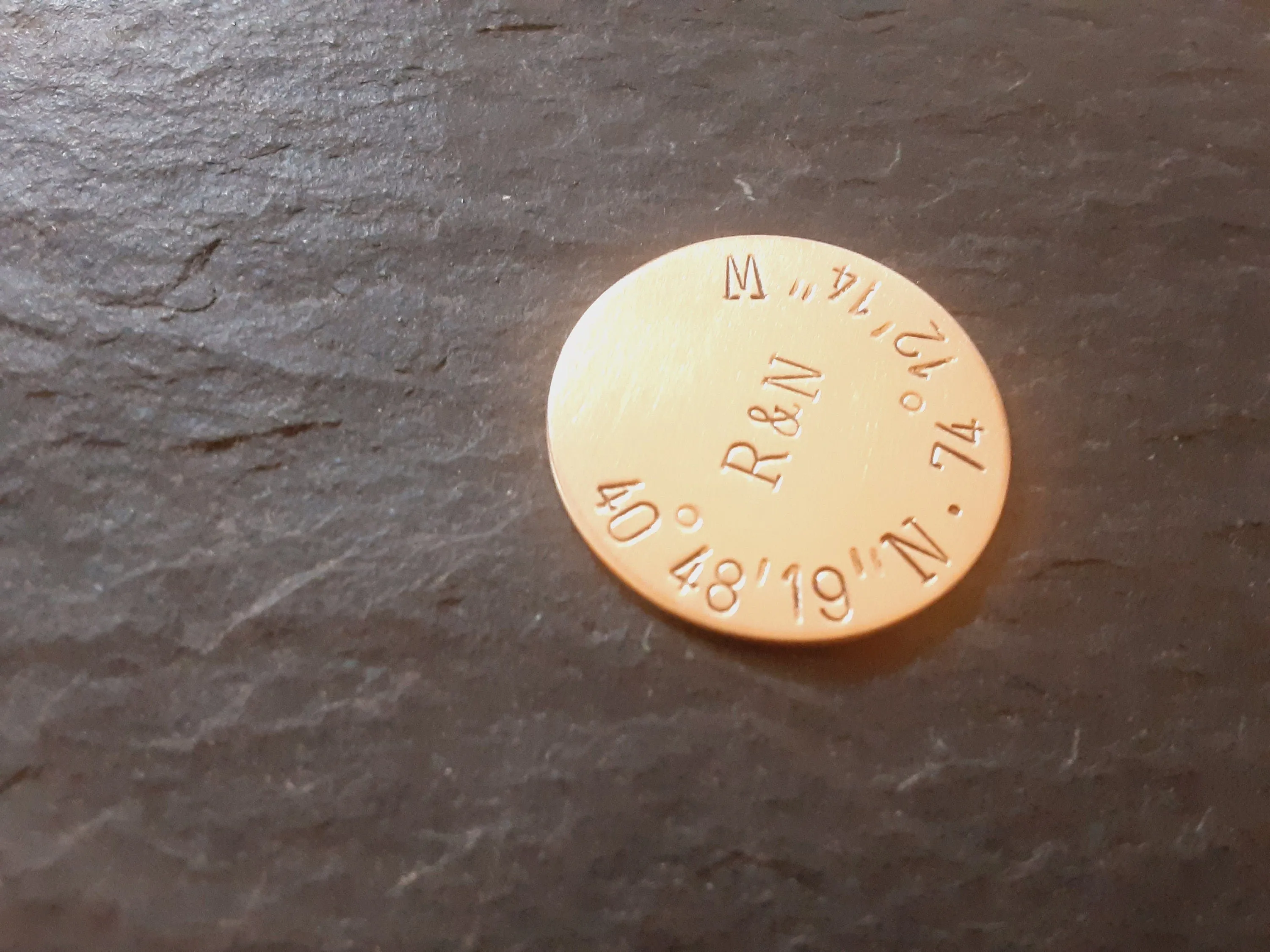 Bronze golf ball marker with latitude longitude