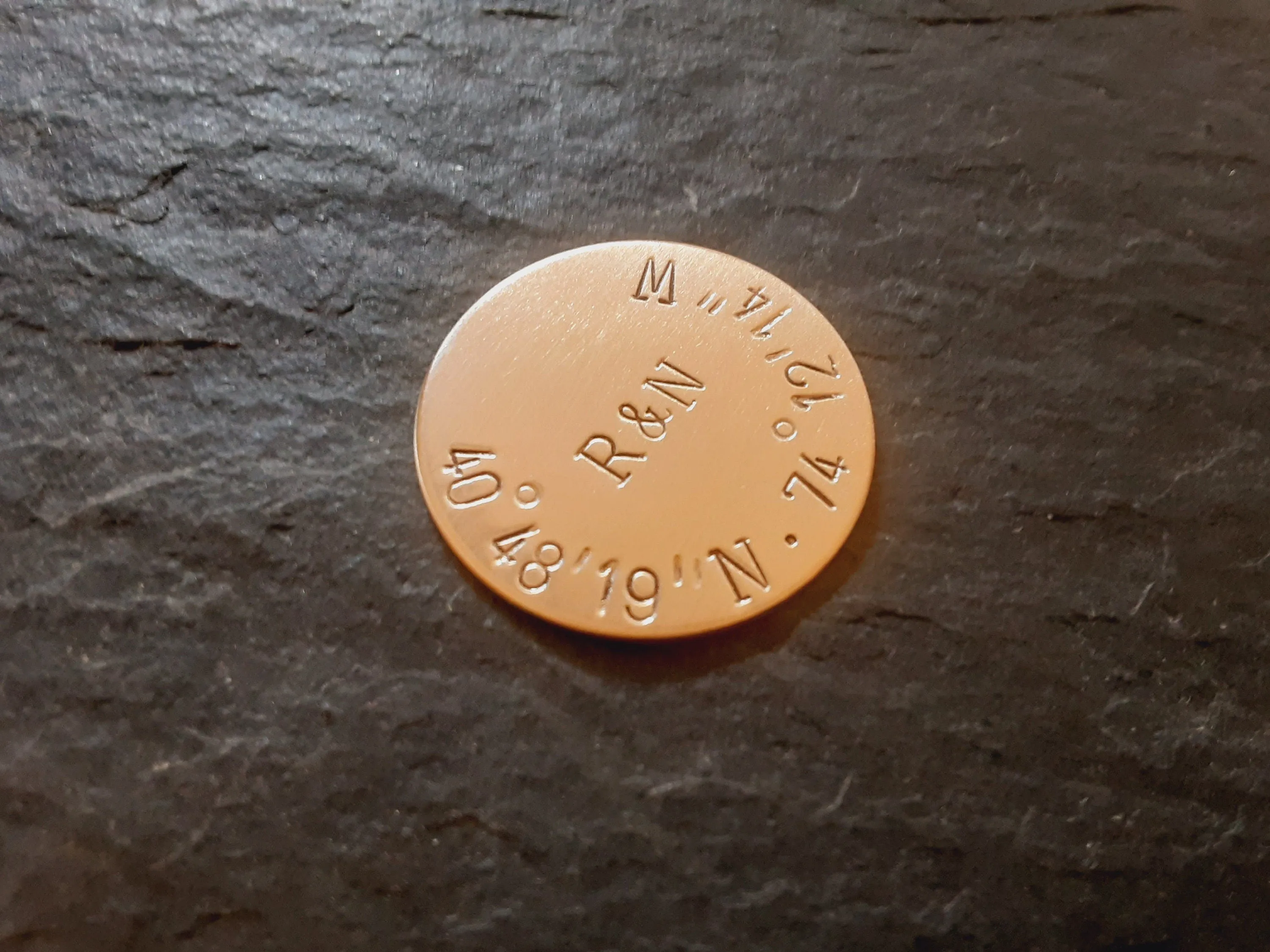 Bronze golf ball marker with latitude longitude
