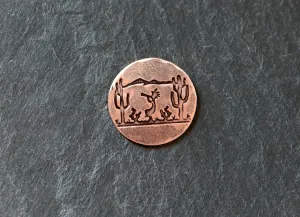 Golf ball marker with saguaro cacti and Kokopelli on copper