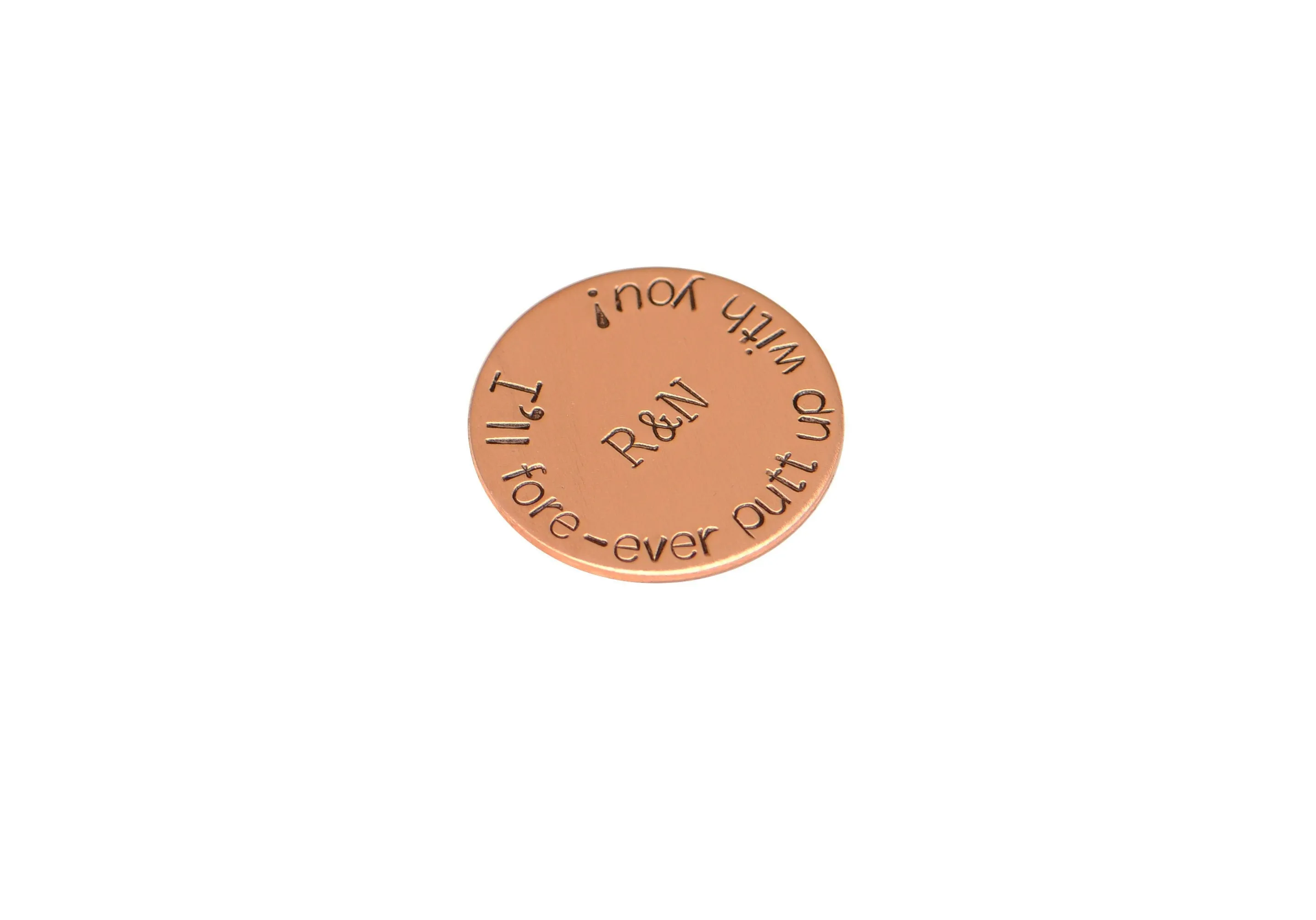 Initials on copper golf ball marker